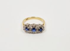 Gold-coloured metal, blue and white stone triple oval cluster ring set three oval blue stones,