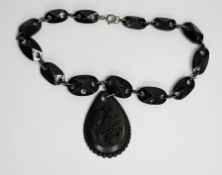 Victorian necklace having engraved and pierced oval links fruiting vine carved teardrop shape