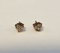 Pair gold-coloured metal and white stone set earrings, each set three small white stones, probably