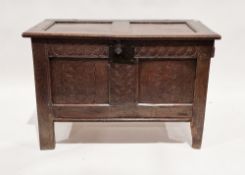 18th century oak coffer, the hinged two panel lid opening to an empty space, the two panel front