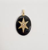 Victorian black onyx oval mourning pendant, the front with applied yellow-metal star set with