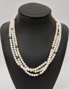 Three-strand cultured pearl necklace, pearls of uniform size, 9k gold clasp stamped 375 and 9k