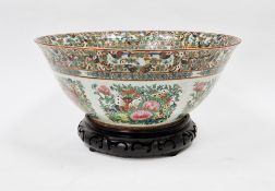 Late 19th/early 20th century Chinese famille rose porcelain bowl raised on a carved wooden stand,