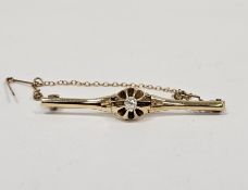 Gold-coloured metal and diamond bar brooch set old cut stone, in pierced flowerhead claw mount,