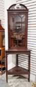 Edwardian mahogany corner cabinet in the George lll manner, the upper section with pierced broken