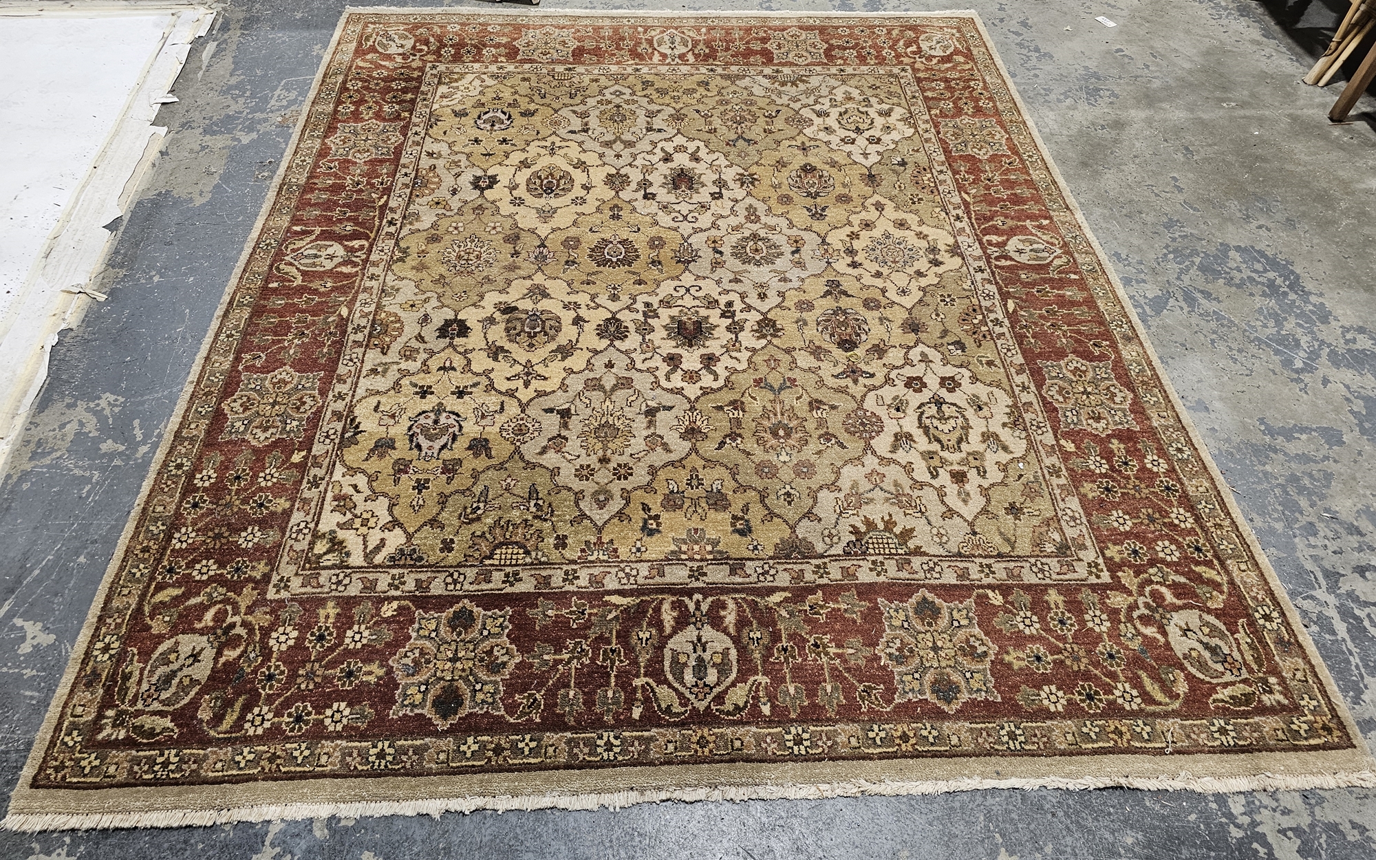 G.H. Frith Ltd Oriental cream ground rug with central floral lozenge pattern field, multiple