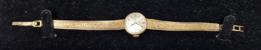 Lady's 9ct gold Tissot wristwatch, the polished circular dial having raised gilt baton hour markers,