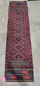 Eastern wool runner with lozenge decoration in red and midnight blue, geometric borders, 262cm x