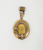 19th century yellow metal oval locket pendant, the front set with a raised band in the form of a