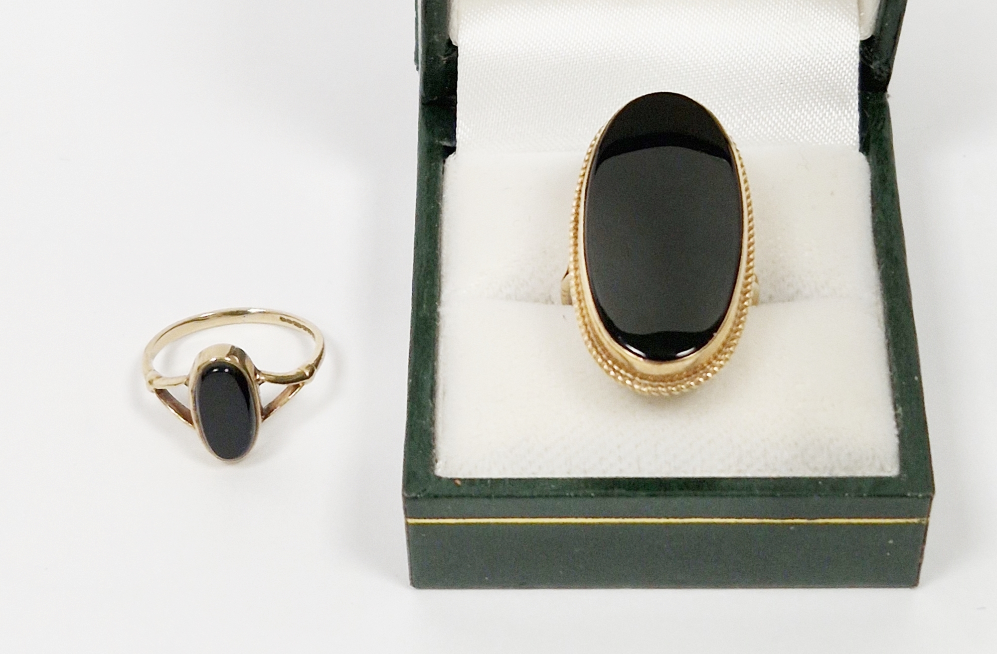 9ct gold and black onyx large oval ring (size O) and 9ct gold and onyx small oval ring (size J1/
