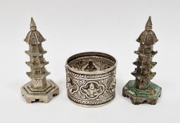 Pair of Chinese white metal pepperettes in the form of pagodas stamped ' On Hing ' to base, 7cm high