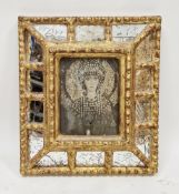 Venetian-style sectional cushion wall mirror in a gilt and wooden frame, the central mirror replaced