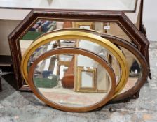Collection of four mirrors including an oval gilt-effect framed mirror, 76cm long, an oak oval