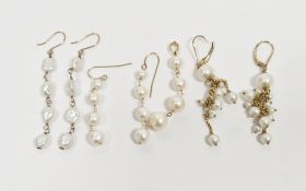 Three pairs of gold pearl pendant drop earrings and another single pearl drop earring