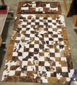 Pieles Pipsa cowhide rug formed from a patchwork of squares, 180cm x 120cm together with another