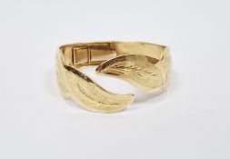 18k yellow gold hinged torque bangle, the front shaped in the form of leaves with brushed and