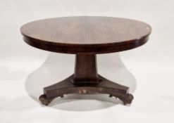 William IV rosewood centre table, the circular tilt top raised on a triangular chamfered inverted
