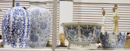 Fluted lidded jar bearing foliate design in blue and white, another tall blue and white vase bearing