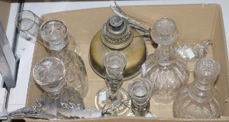 Four varying moulded glass decanters, a pair of cut glass candlesticks, a pair of silver plated