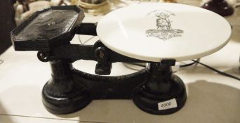 Antique cast iron scales with ceramic weighing plate bearing Justice with banner above reading