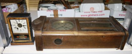 American 19th century mantel/alarm clock and an oak cased early to mid 20th century wall clock (2)