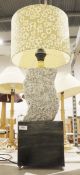 Table lamp comprising a granite waved form top and brushed metal base