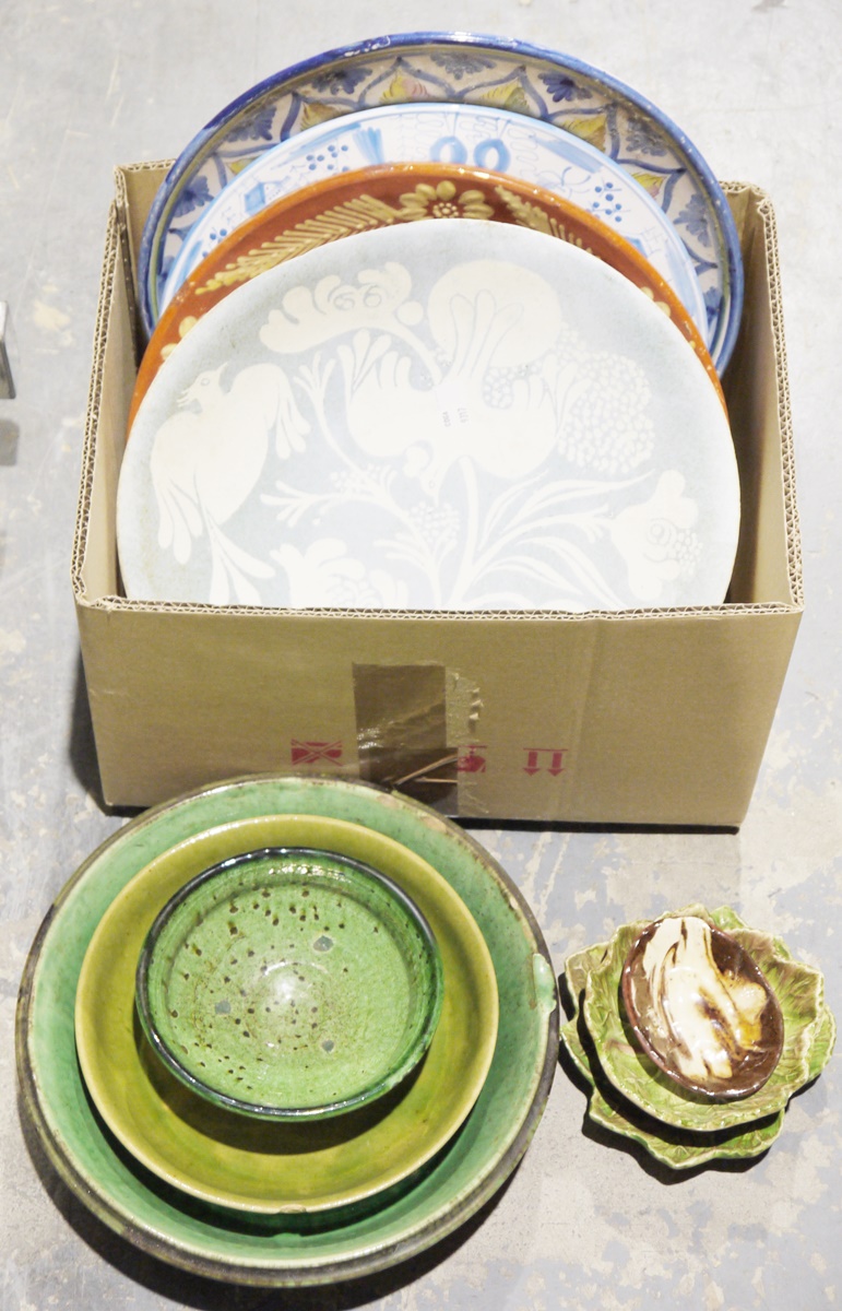 Large blue ground ceramic serving plate with floral and bird design, a green glazed studio pottery