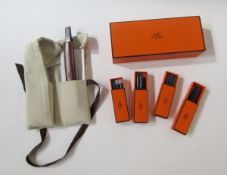 Hermes Nautilus fountain pen in black and silver with oxblood leather case, four boxes of cartridges