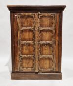 Indian/Middle Eastern hardwood cabinet / cupboard, the moulded cornice over two iron mounted panel