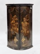 George III black japanned bowfronted hanging corner cabinet, the two doors with gilt chinoiserie