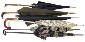 Six early 20th century umbrellas and parasols including horn-handled umbrella carved in the form