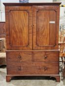 George III mahogany linenpress with greek key moulded cornice over pair panel doors opening to