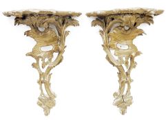 Pair of carved wooden rococo style bracket shelves with foliate scroll decoration, 48cm high