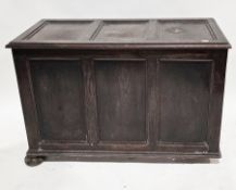 Oak three-panel coffer, the hinged lid opening to an empty space and raised on squat bun feet (one