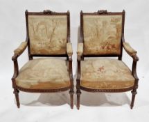 Pair of French walnut framed open armchairs, the square backs with top rails carved with musical