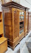 Early 20th century walnut and burr walnut inverted breakfront triple wardrobe, the moulded cornice