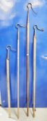 Four antique shepherd's crooks, possibly Scottish, with iron hooks and long turned wooden handles,