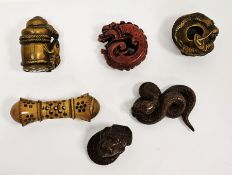 Four Japanese wooden carved netsukes, all signed, including a coiled snake, frog on a sea