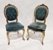 Pair of French giltwood salon chairs in the Louis XVI manner, the frames of the oval backs carved