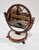 19th century walnut swing dressing mirror, the circular cushion framed mirror held on a wishbone-