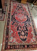 Hand knotted Iranian rug with scarab beetle tribe borders in blues, green, pink, grey and peach,