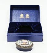 Early 19th century Bilston enamel oval patchbox, the cover decorated with a basket of flowers and