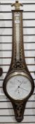 Mahogany verre églomisé cased wheel combination barometer and thermometer in the Regency manner by