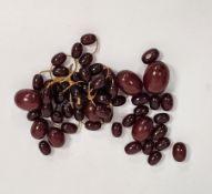 Collection of cherry amber bakelite oval beads, largest bead 2.5cm long Condition Report Weight