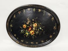 19th century black lacquered papier-mache oval tray, hand decorated with floral sprays and gilt