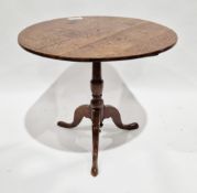 George III oak supper table, the circular tilt-top raised on a turned vase-shaped support and