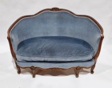 French walnut framed settee in the Louis XV manner, the shaped moulded back having central floral