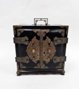 Chinese ebonised table top cabinet, the two doors with brass mounts and opening to a bank of seven