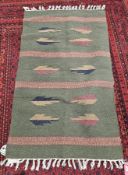 Indian 80% cotton 20% jute rug, sage colour with designs in blue, brown, gold with pink and four