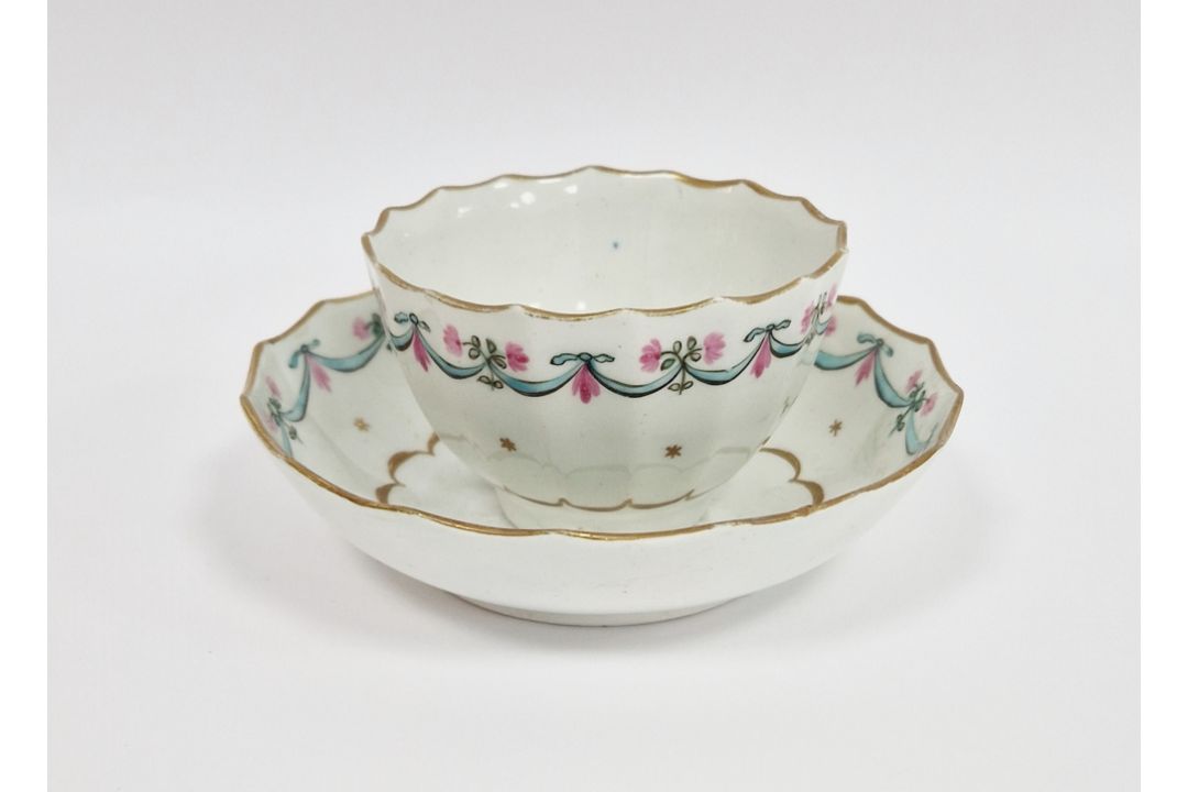 Lowestoft porcelain fluted teabowl and saucer, circa 1790, painted with turquoise and pink swags
